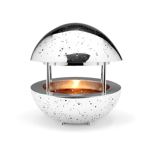 Image of silver tea light candle sculpture, with Milky Way star constellations of northern & souther hemispheres illuminated by lit candle