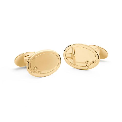 Image of yellow gold oval cufflink with personalised engraving for groom's wedding